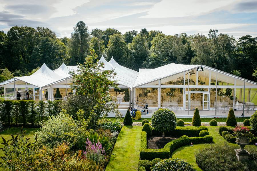 Marquee complex beside a formal garden
