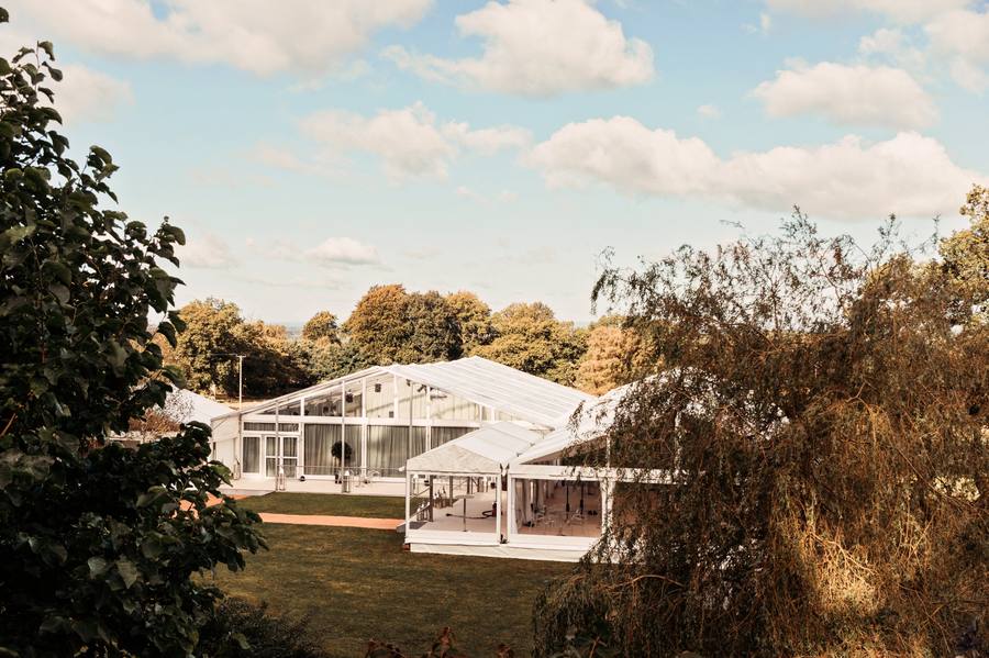 Marquee seen through trees on a bright afternoon