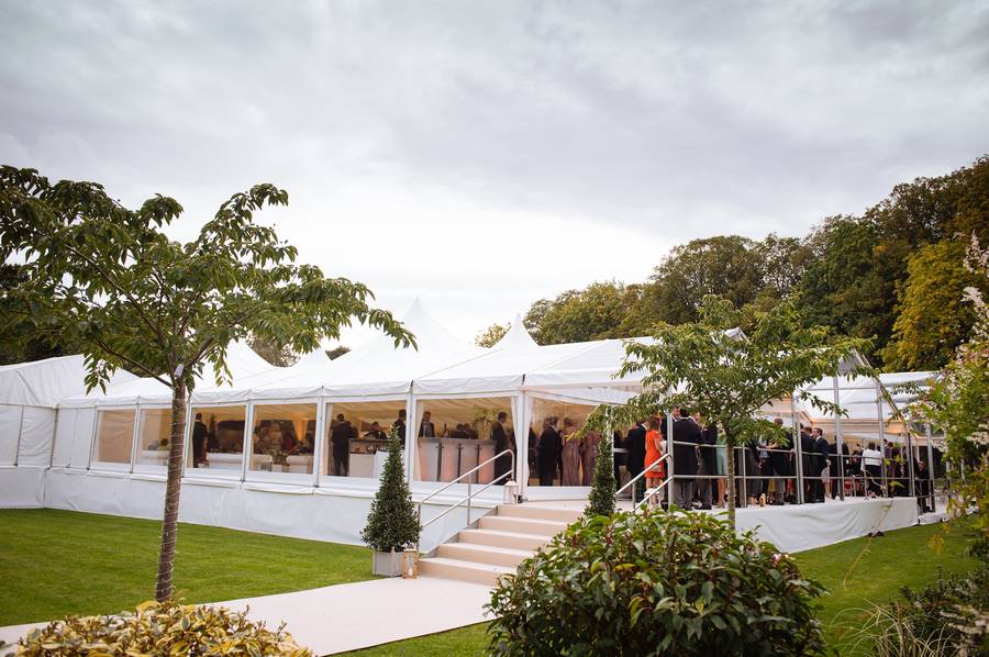 Marquee with a stepped entrance and guests on the terrace at dusk